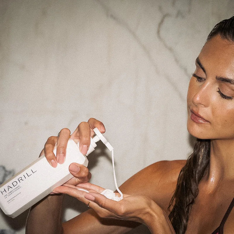 Model dispensing Hadrill The Conditioner, part of The Trio hair care set